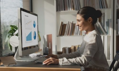woman looking at graphs on computer