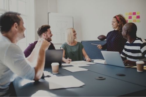 five people meeting sharing ideas