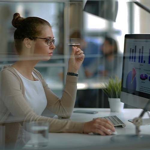 woman reviewing graphs on computer