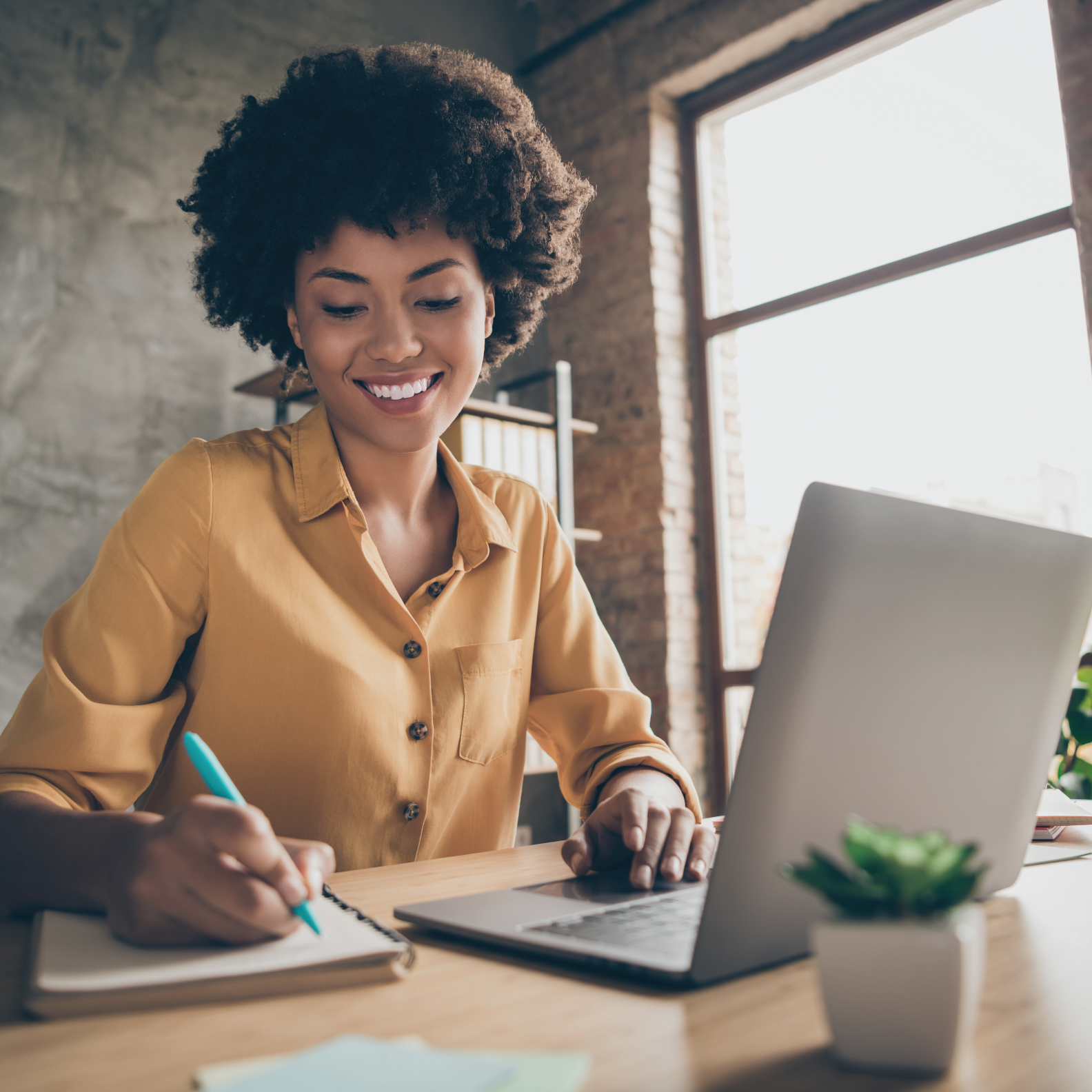 smiling woman taking notes in agenda