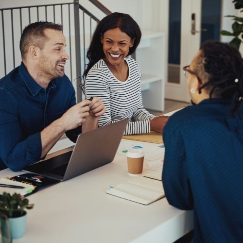 three people talking and smiling