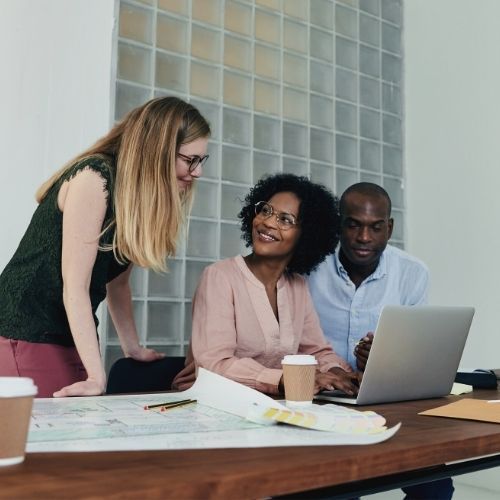 two women and a man looking for a solution